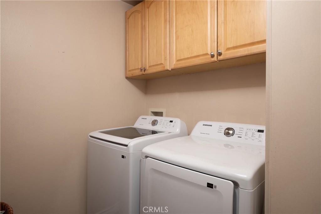 Laundry Room: Dedicated laundry space offers side-by-side washer and dryer placement with upper cabinetry for convenient - 36 Vienna, Newport Beach CA 92660 - photo 31