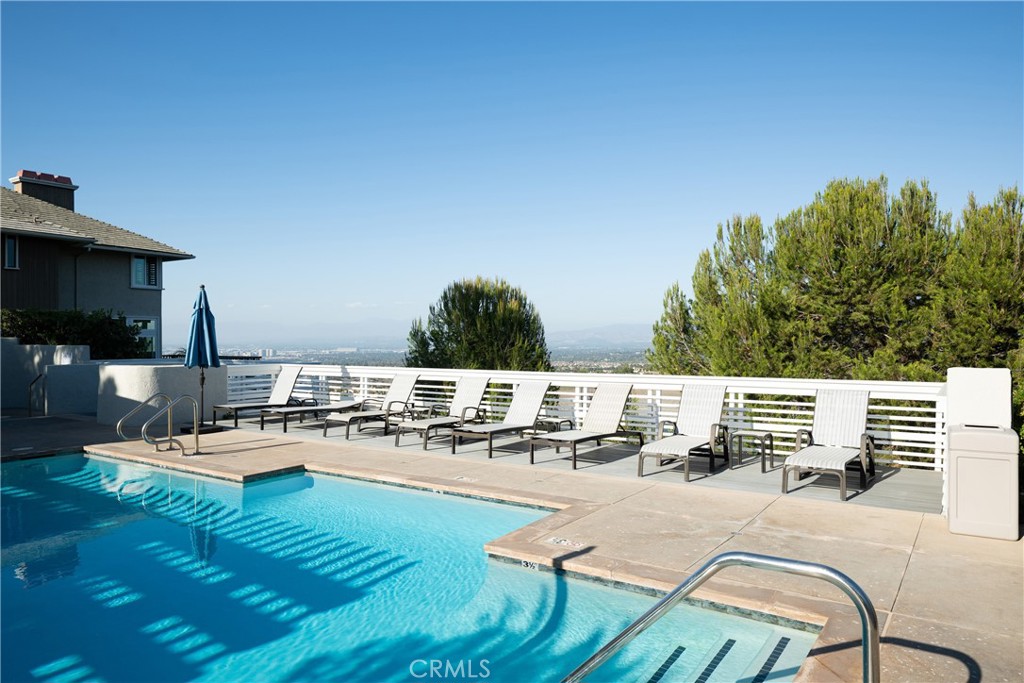 Community Pool: Community pool and sundeck offer space for swimming and relaxing, complemented by elevated views across - 36 Vienna, Newport Beach CA 92660 - photo 38