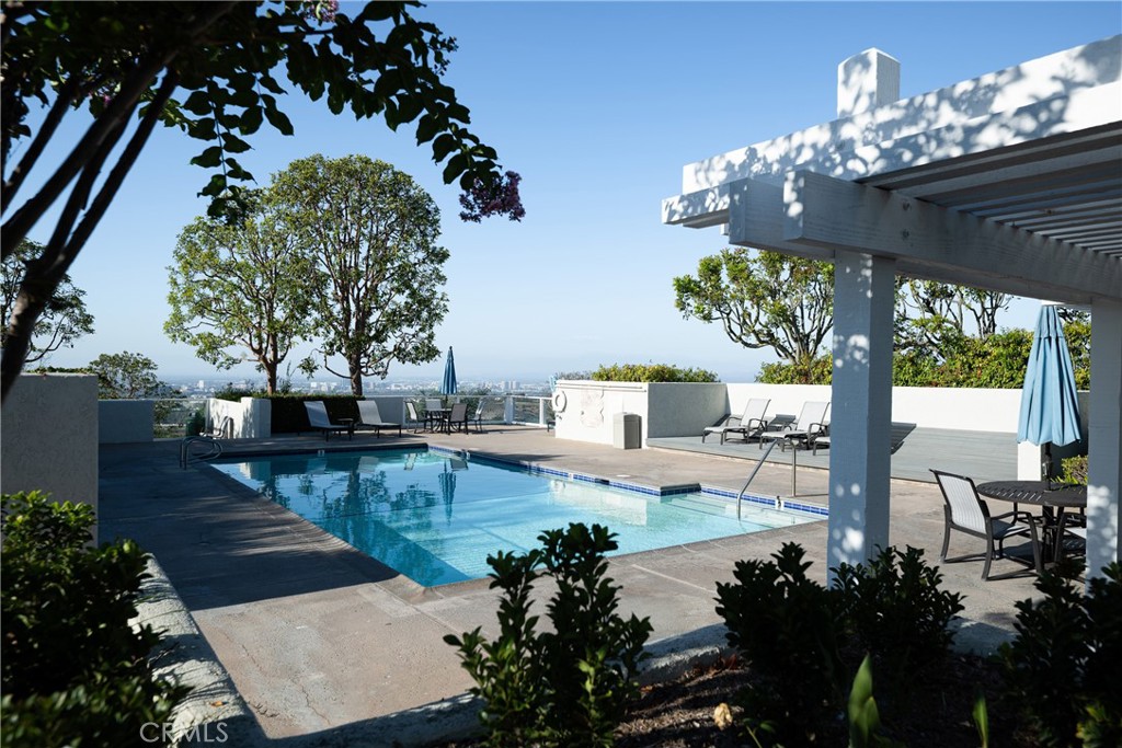 Community Pool Area: Landscaped pool area features ample deck space, lounge seating, outdoor tables, and a shaded pergol - 36 Vienna, Newport Beach CA 92660 - photo 39