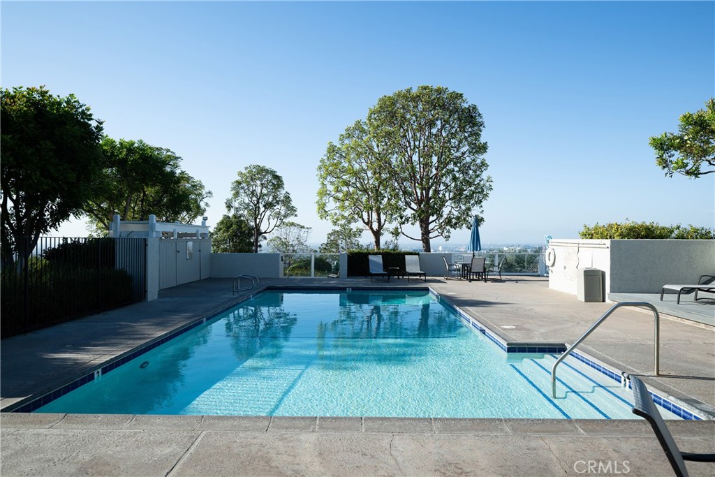 Community Pool: Another view of the community pool highlights convenient entry steps, surrounding deck space, and seatin - 36 Vienna, Newport Beach CA 92660 - photo 40