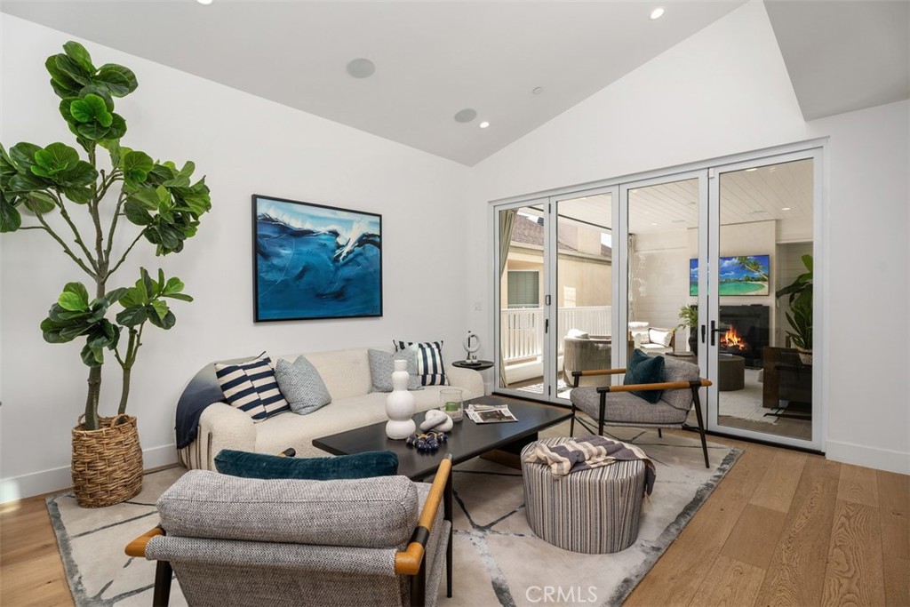 Family Room view with bifold doors to second floor patio fireplace and TV (Fireplace and TV modified for photo) - 418 1/2 Larkspur, Newport Beach CA 92625 - photo 7