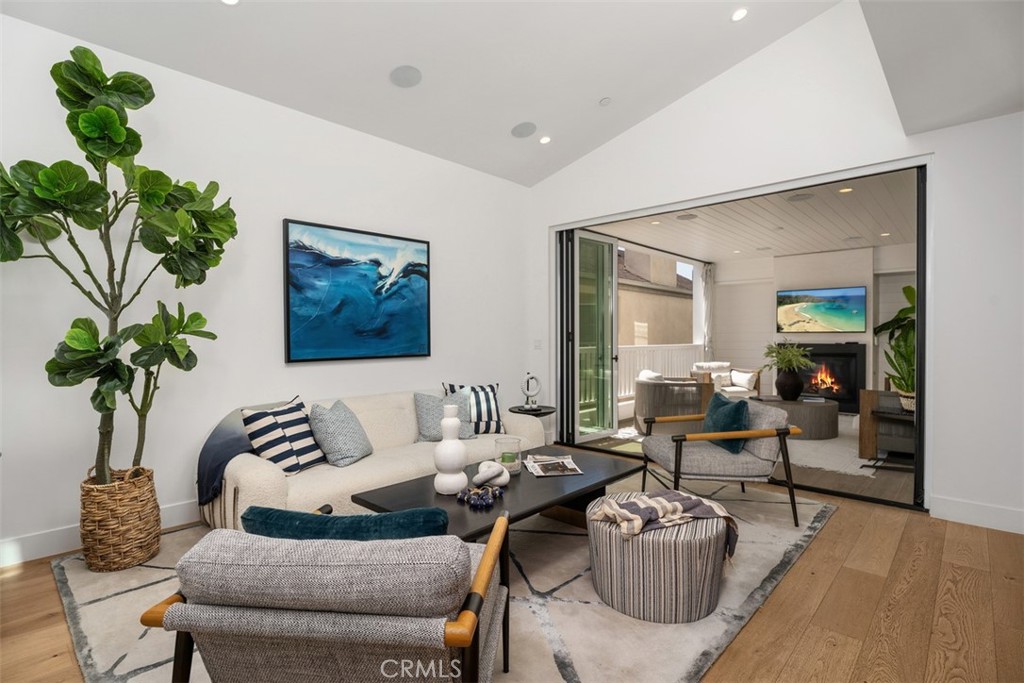Bifold doors open for seamless indoor outdoor living space (TV and Fireplace modified for photo) - 418 1/2 Larkspur, Newport Beach CA 92625 - photo 8