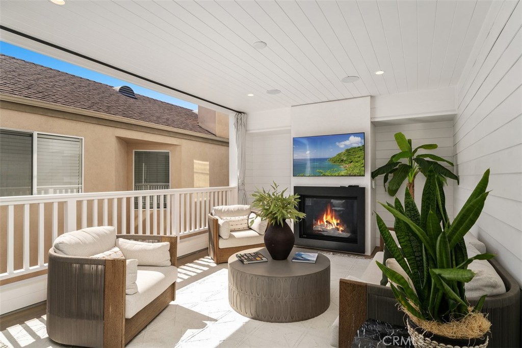 Second Floor Patio with ceramic faux wood tile with TV and fireplace. (TVand fireplace modified for photo) - 418 1/2 Larkspur, Newport Beach CA 92625 - photo 20