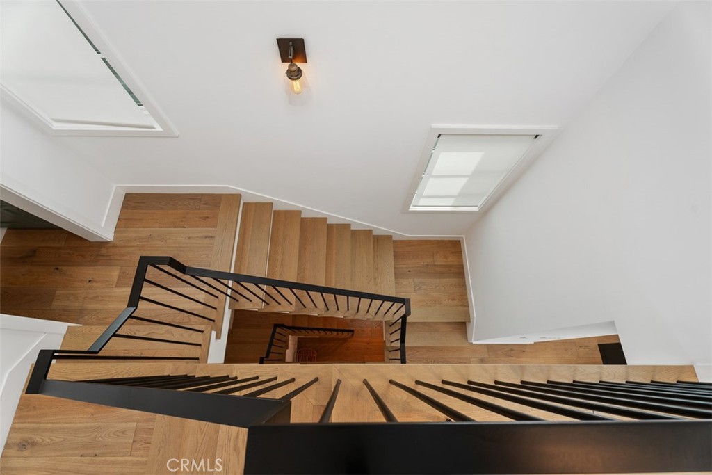 Birdseye view Stairwell looking from third floor down to entry and automatic shades on windows - 418 1/2 Larkspur, Newport Beach CA 92625 - photo 25