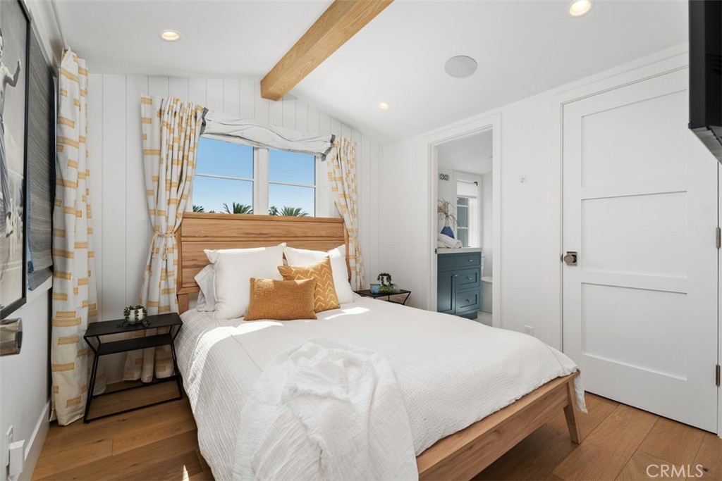 Secondary Bedroom located on third floor with decorative wood beam and queen size bed, ensuite bathroom and closet. - 418 1/2 Larkspur, Newport Beach CA 92625 - photo 26