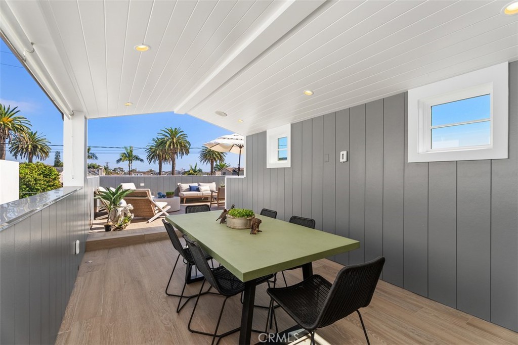Third Floor outdoor rooftop patio with covered dining with recessed lighting and privacy shades - 418 1/2 Larkspur, Newport Beach CA 92625 - photo 29