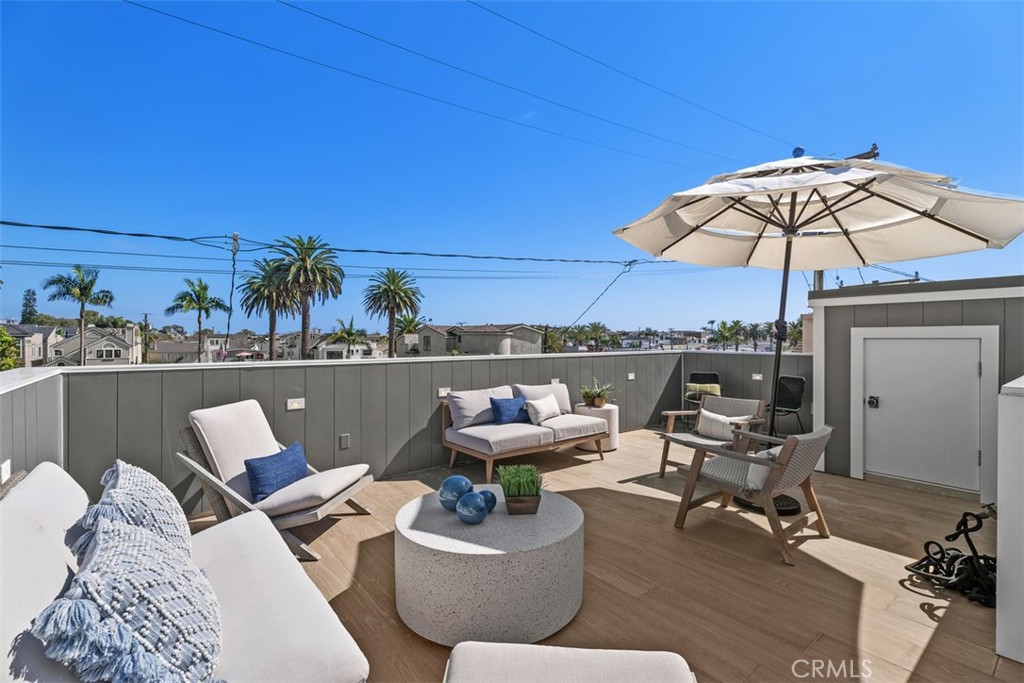 Third Floor outdoor rooftop patio with ceramic wood faux tile. Built-in gas line for BBQ or fire-pit and hose-bib. - 418 1/2 Larkspur, Newport Beach CA 92625 - photo 30