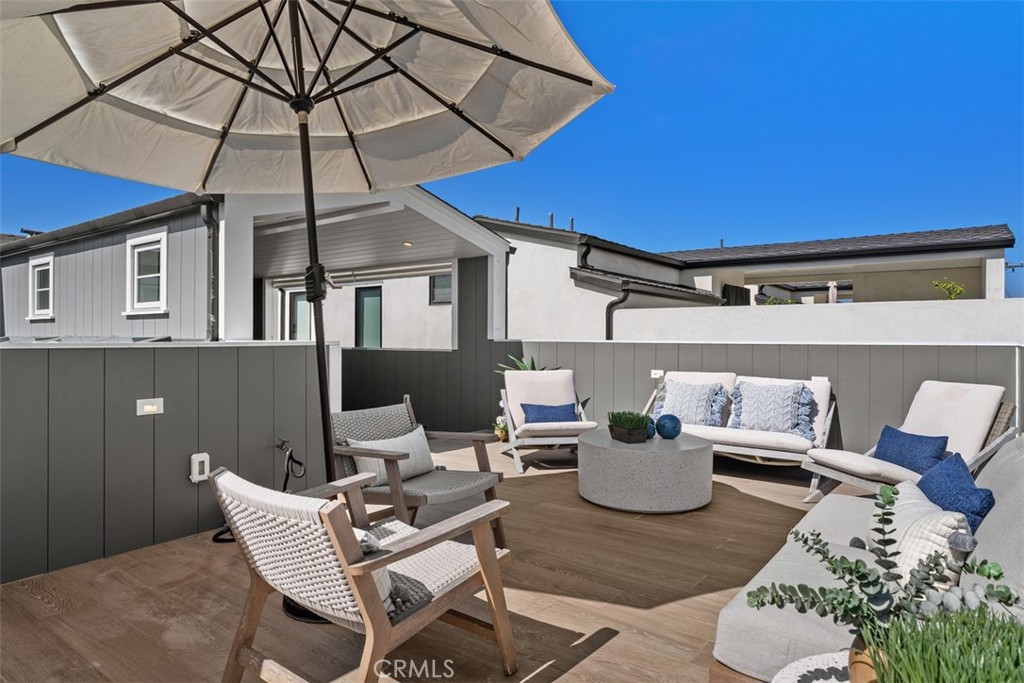 Third Floor Rooftop Patio looking at enclosed dining area with outdoor wall patio lighting - 418 1/2 Larkspur, Newport Beach CA 92625 - photo 32