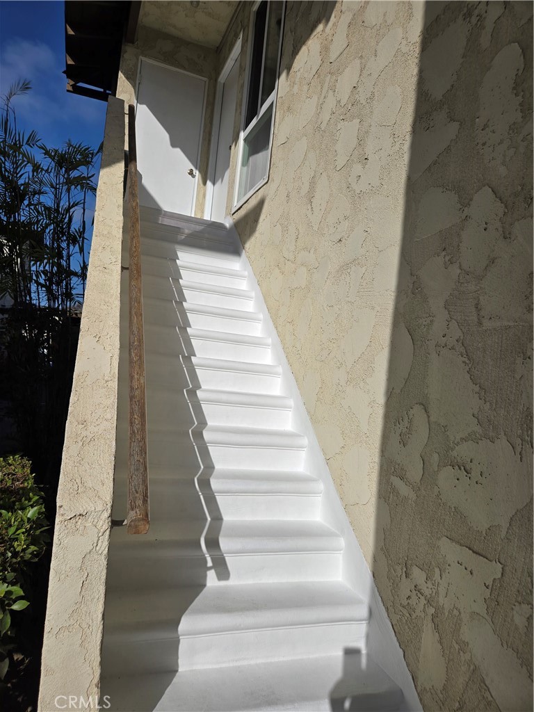Stairs leading to unit with extra storage closet next to front door entry - 4233 Hilaria, Newport Beach CA 92663 - photo 2