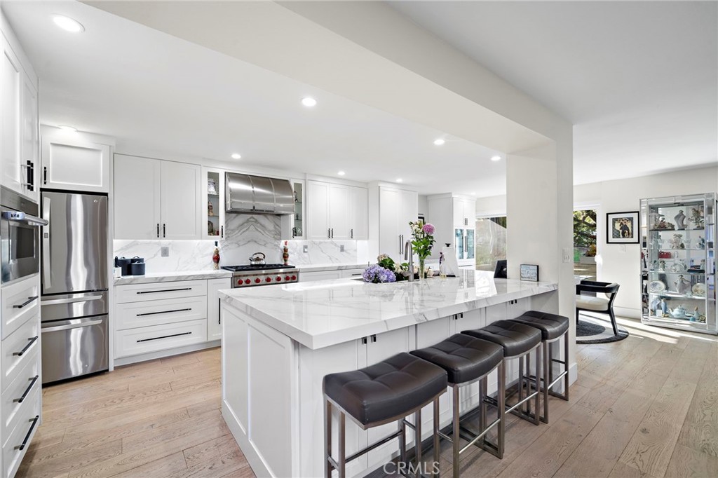 The kitchen island is 118" x 57" long, custom range hood, Wolf 6 burner stove-convection & conventional oven, plus Wolf - 526 Vista Grande, Newport Beach CA 92660 - photo 5