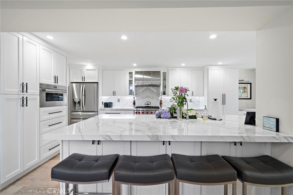 Enormous amout of storage space under the island a cabinets. The island has seating and plenty of room for everyone to g - 526 Vista Grande, Newport Beach CA 92660 - photo 6