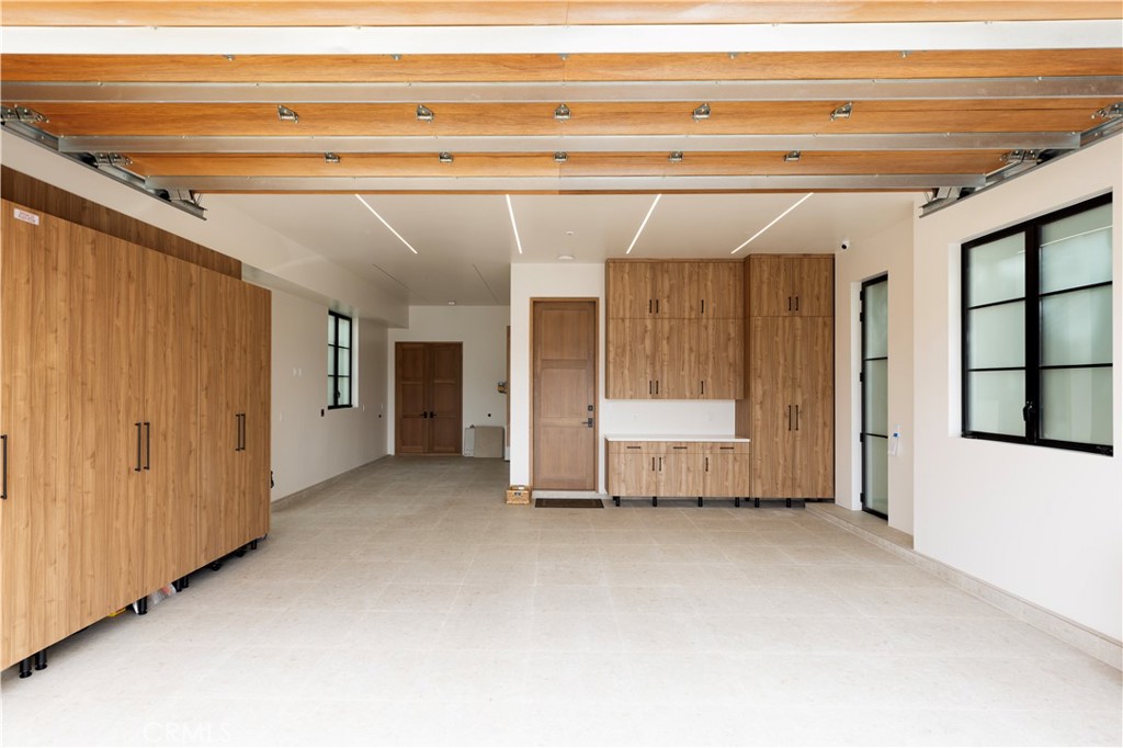 Showroom garage with custom storage, electrical and water filtration system. Room for a car lift - 615 Lido Park, Newport Beach CA 92663 - photo 19