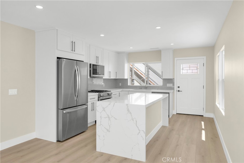 Kitchen has large island with bar seating - 806 W Balboa Boulevard Front, Newport Beach CA 92661 - photo 14