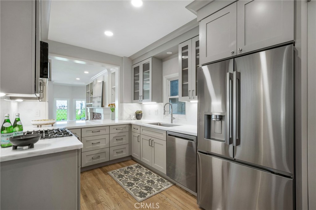 Newly remodeled kitchen with stainless steel appliances, overlooking the living room and ocean views - 920 E Oceanfront, Newport Beach CA 92661 - photo 10