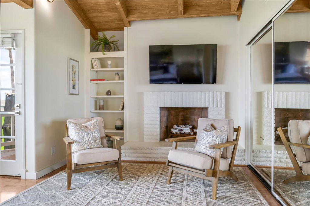 Gas fireplace in primary bedroom with seating area - 920 E Oceanfront, Newport Beach CA 92661 - photo 18