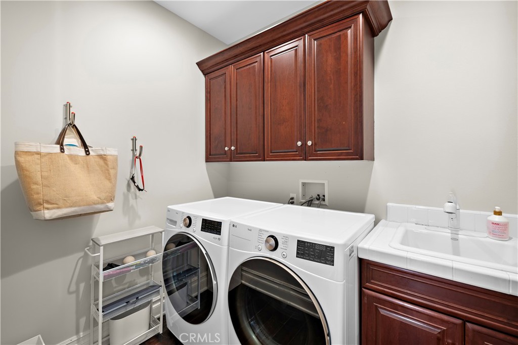 Downstairs laundry room with utility sink - 96 Old Course, Newport Beach CA 92660 - photo 29