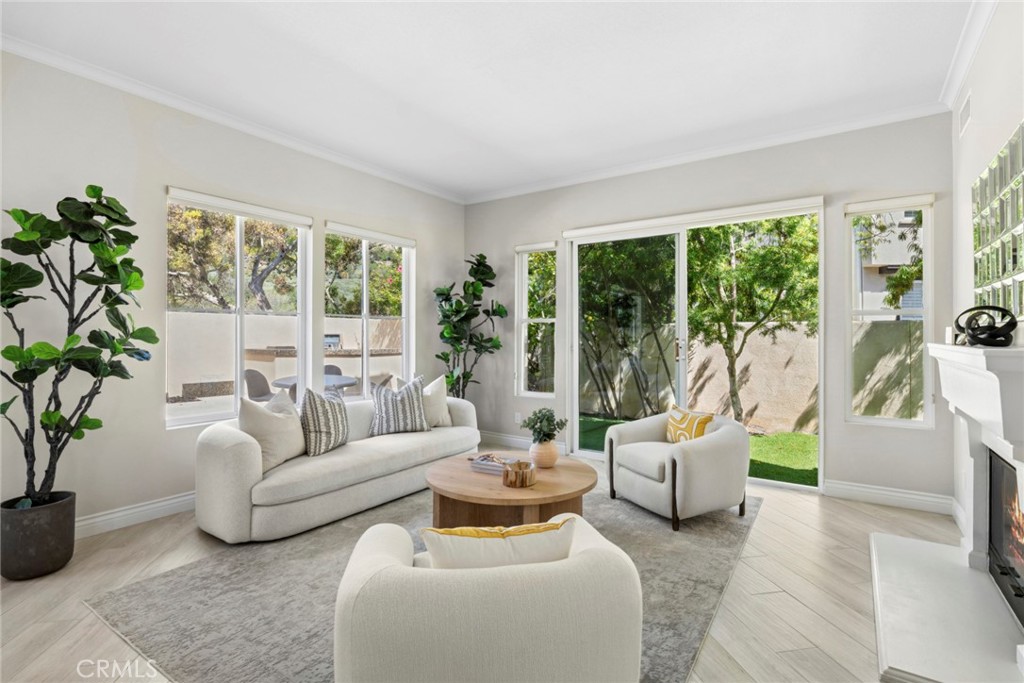 Fireplace in living with easy access to aside yard with citrus trees. - 6 Tidal Surf, Newport Coast CA 92657 - photo 4
