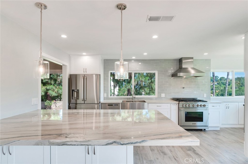 Completely remodeled kitchen features center island with quartzite counter, stainless Dacor appliances, gorgeous view! - 11761 Highview Drive, North Tustin CA 92705 - photo 1