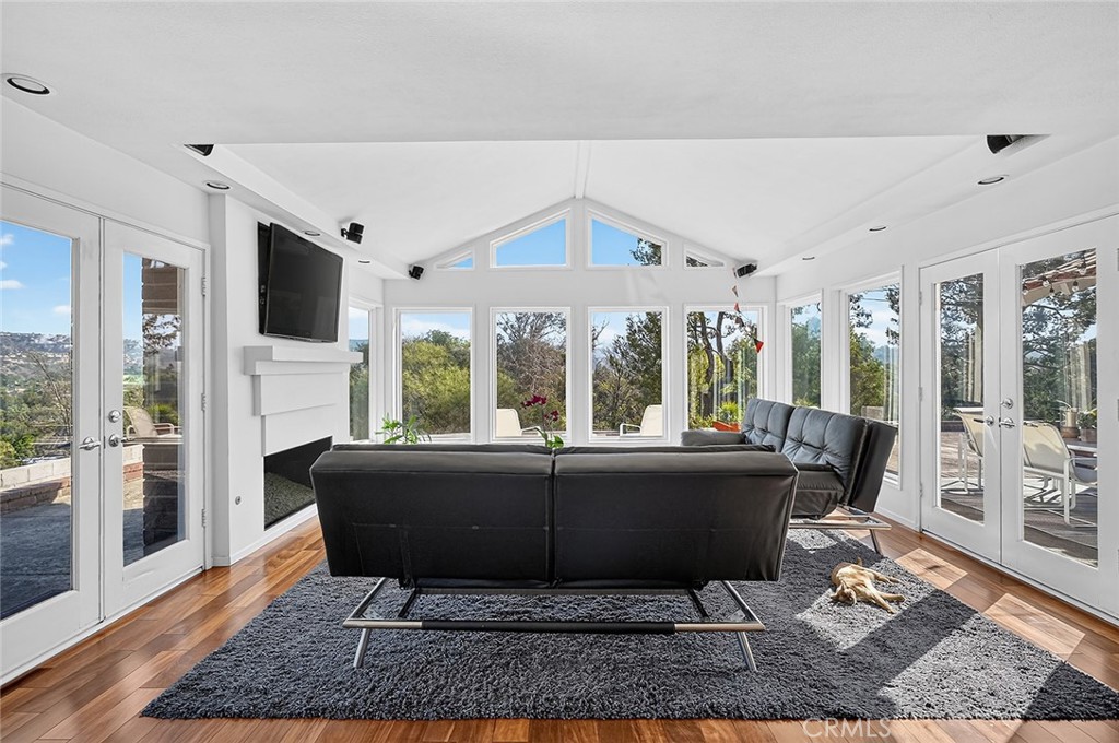 The family room has a fireplace and French doors on 2 sides that access the patios - 10571 Morada, Orange CA 92869 - photo 16