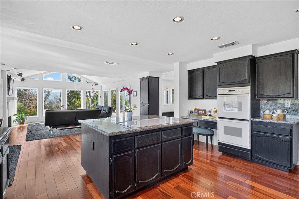 View of the kitchen island to the family room - Double ovens and a desk - 10571 Morada, Orange CA 92869 - photo 23
