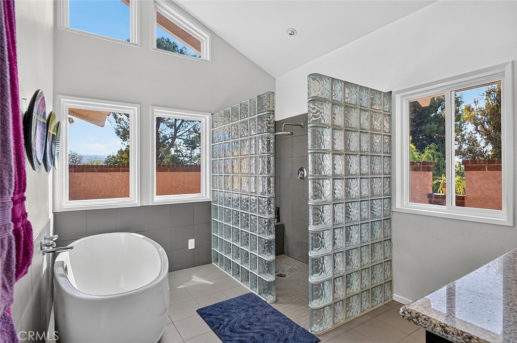 Spa-like primary bath features a freestanding soaking tub and walk in shower - 10571 Morada, Orange CA 92869 - photo 35