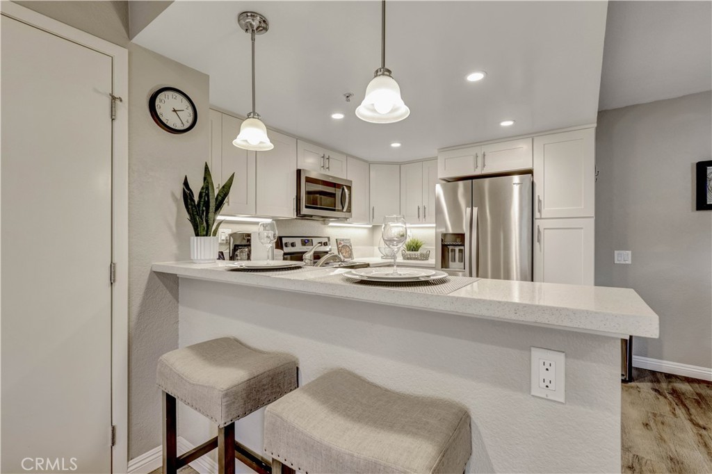 Full Kitchen with Stainless Steel appliances bar seating, and Kitchenware - 129 N Cross Creek, Orange CA 92869 - photo 13