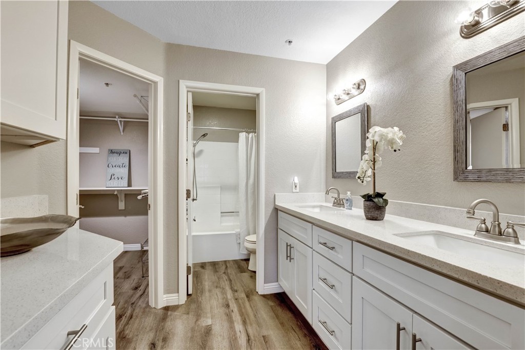 Vanity area with dual sinks. large walk in closet, private door on shower/toilet area. - 129 N Cross Creek, Orange CA 92869 - photo 27