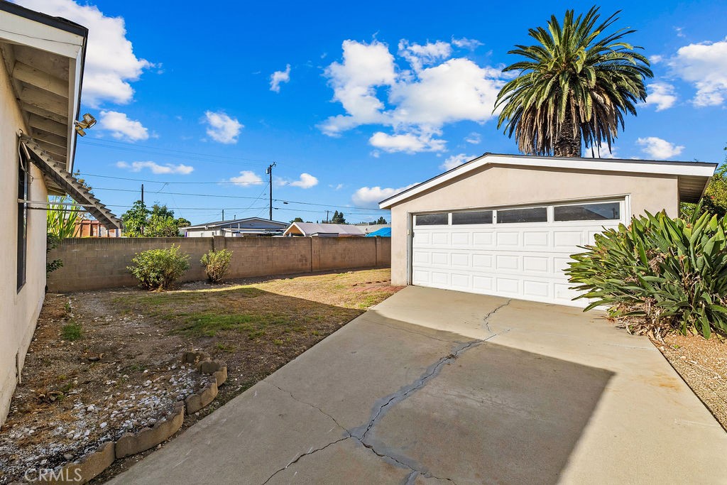 Detached 2-car garage located at the end of the long driveway, providing additional parking and storage possibilities. - 150 S Park, Orange CA 92869 - photo 4