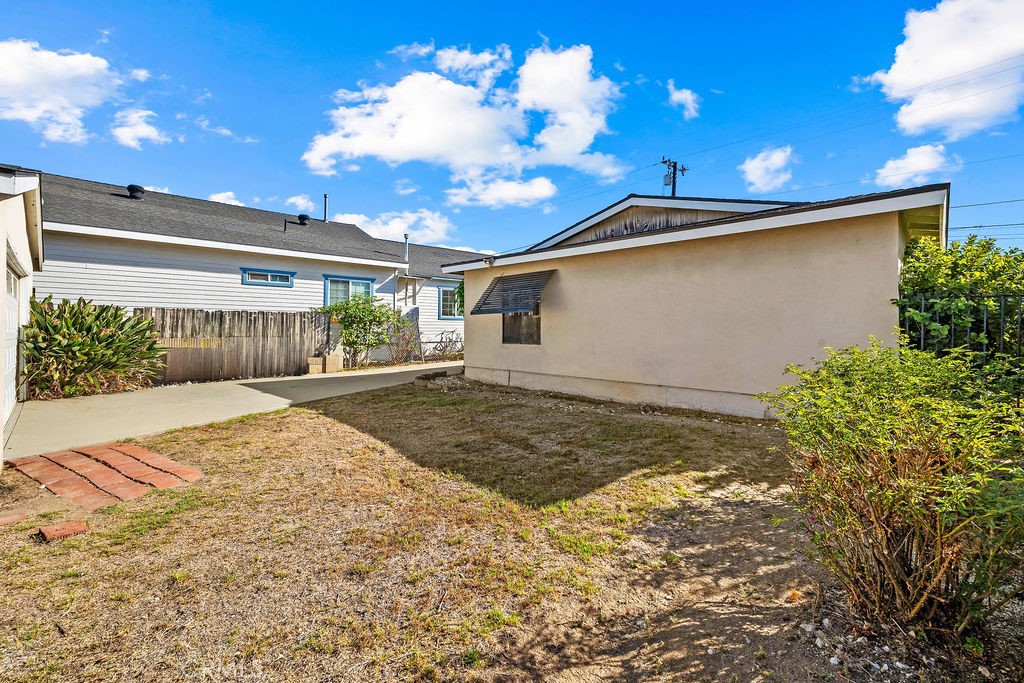 View from the backyard toward the home, highlighting the property's outdoor space and detached layout. - 150 S Park, Orange CA 92869 - photo 9
