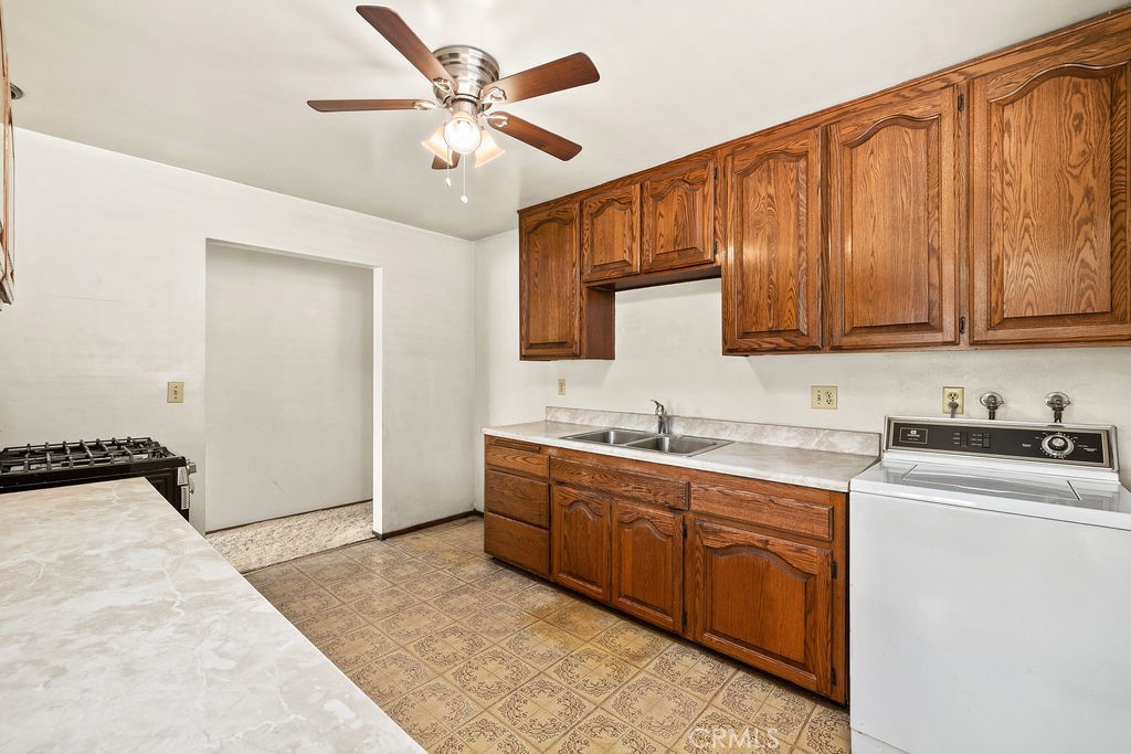 Functional kitchen with wood cabinetry, generous counter space, ceiling fan, and room to update over time to suit your o - 150 S Park, Orange CA 92869 - photo 10