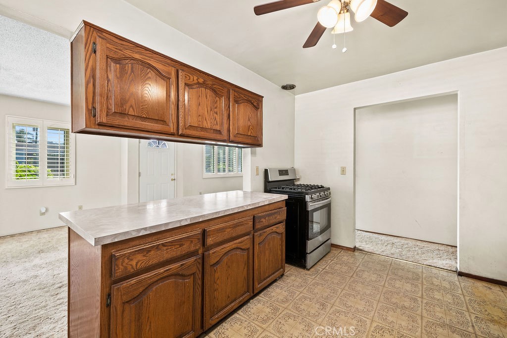 Kitchen features a convenient breakfast counter that opens to the adjoining living and dining area. - 150 S Park, Orange CA 92869 - photo 11