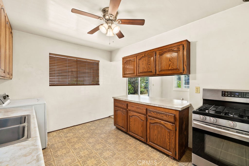 Additional kitchen view showcasing the cabinetry, counter space, window, and functional layout. - 150 S Park, Orange CA 92869 - photo 12