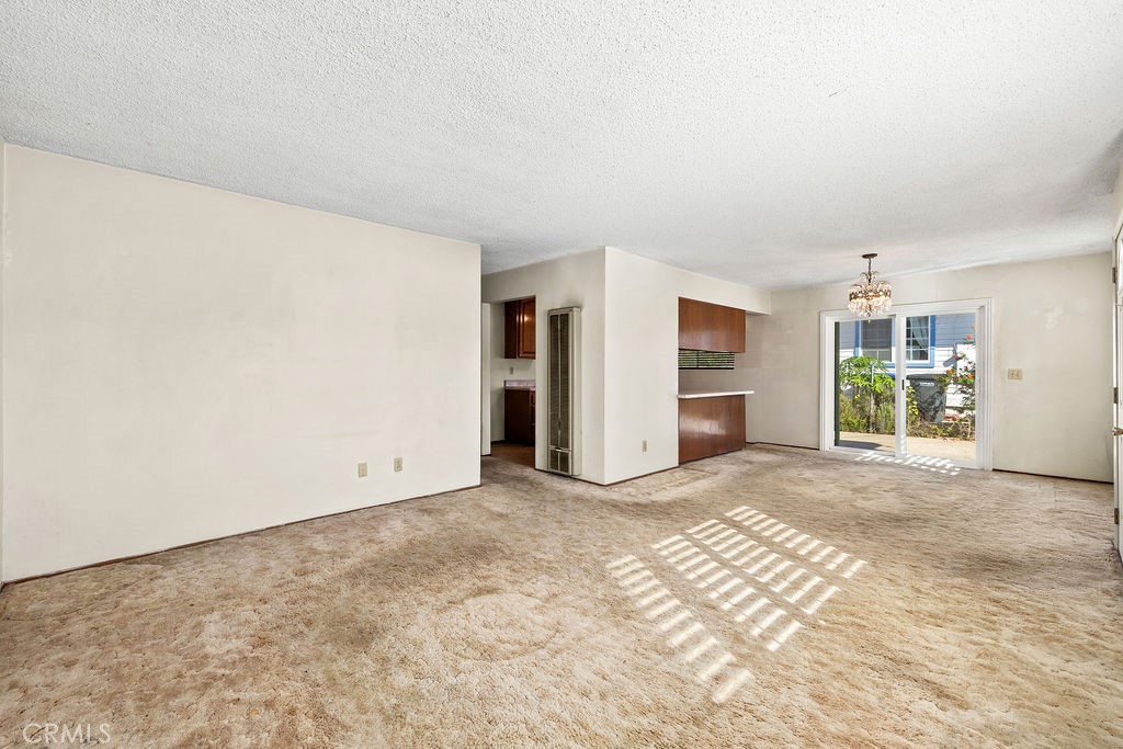Generously sized living room with natural light and an open connection to the dining area and kitchen. - 150 S Park, Orange CA 92869 - photo 15