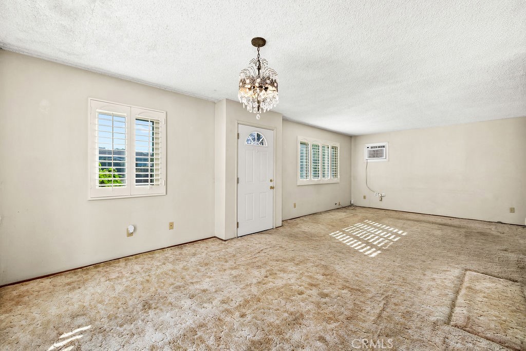 Another view of the spacious living area featuring multiple windows with plantation-style shutters. - 150 S Park, Orange CA 92869 - photo 18