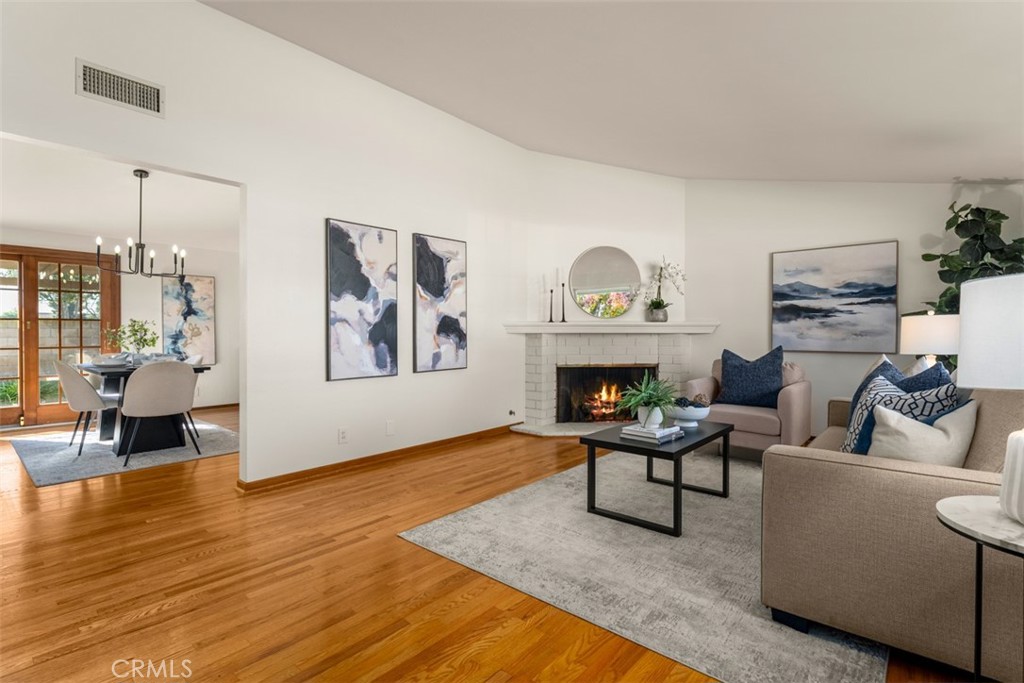 Welcome home! Such a cute home. Beautiful original wood floors. (Fire in the fireplace is digital enhancement). - 2020 W Willow Avenue, Orange CA 92868 - photo 1