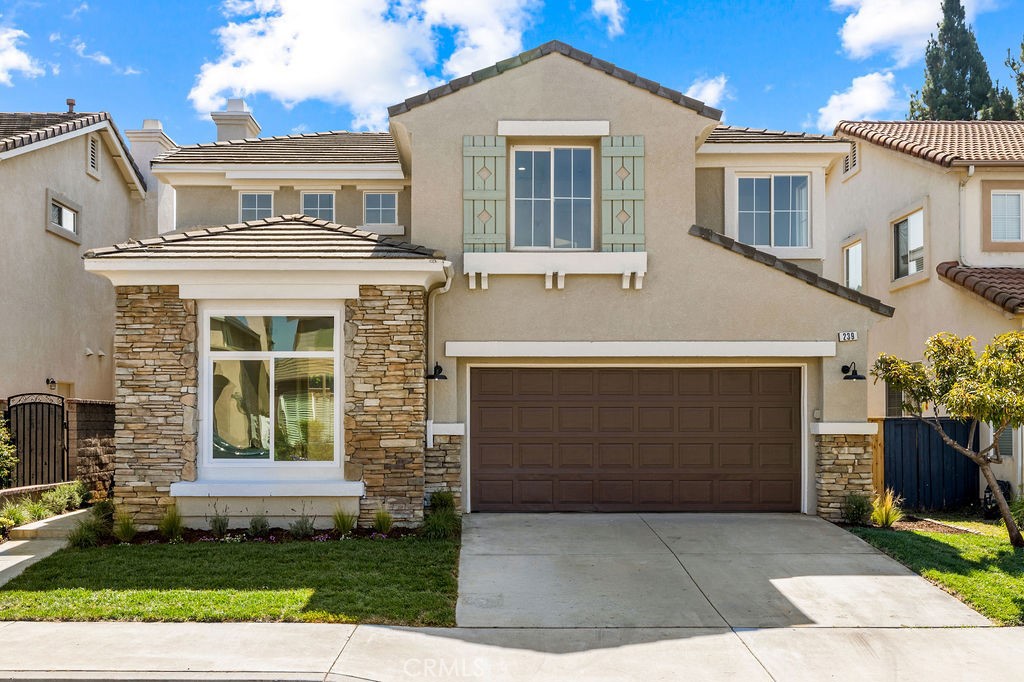Beautifully updated front elevation with stone accents and an inviting curb appeal in the desirable Santiago Hills commu - 239 S Firenza, Orange CA 92869 - photo 1