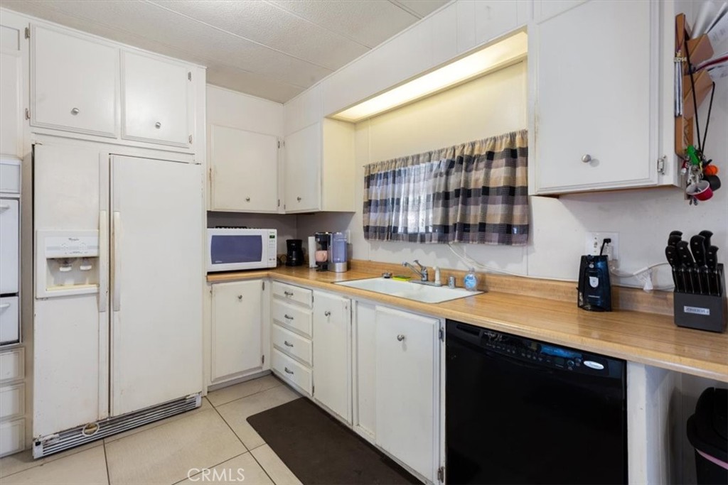 Updated Kitchen with Ample Cabinetry - 300 N Rampart 195, Orange CA 92868 - photo 3