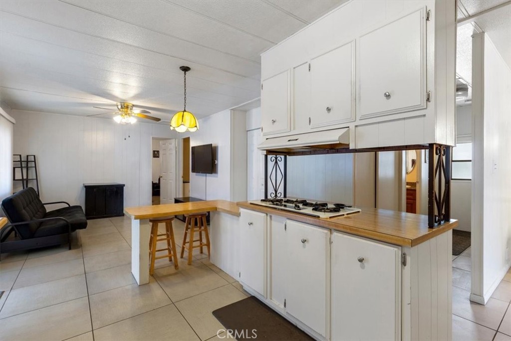 Updated Kitchen with Breakfast Bar and Ample Cabinetry - 300 N Rampart 195, Orange CA 92868 - photo 5