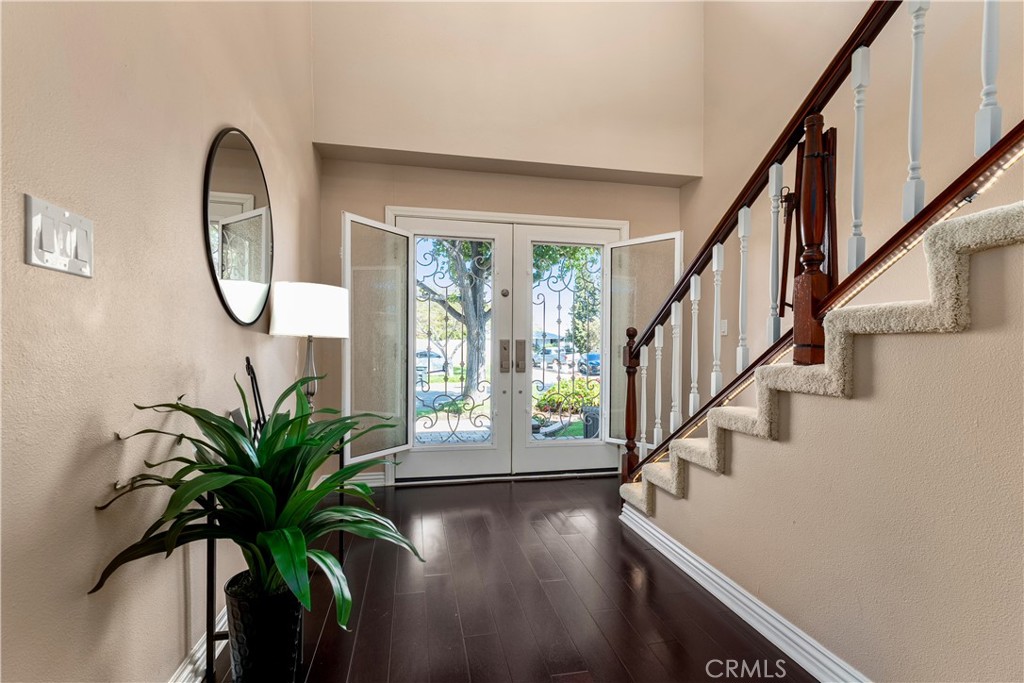 Welcoming front entry with custom doors that are screened and you can open the glass for fresh air. - 390 N Milford Road, Orange CA 92867 - photo 4