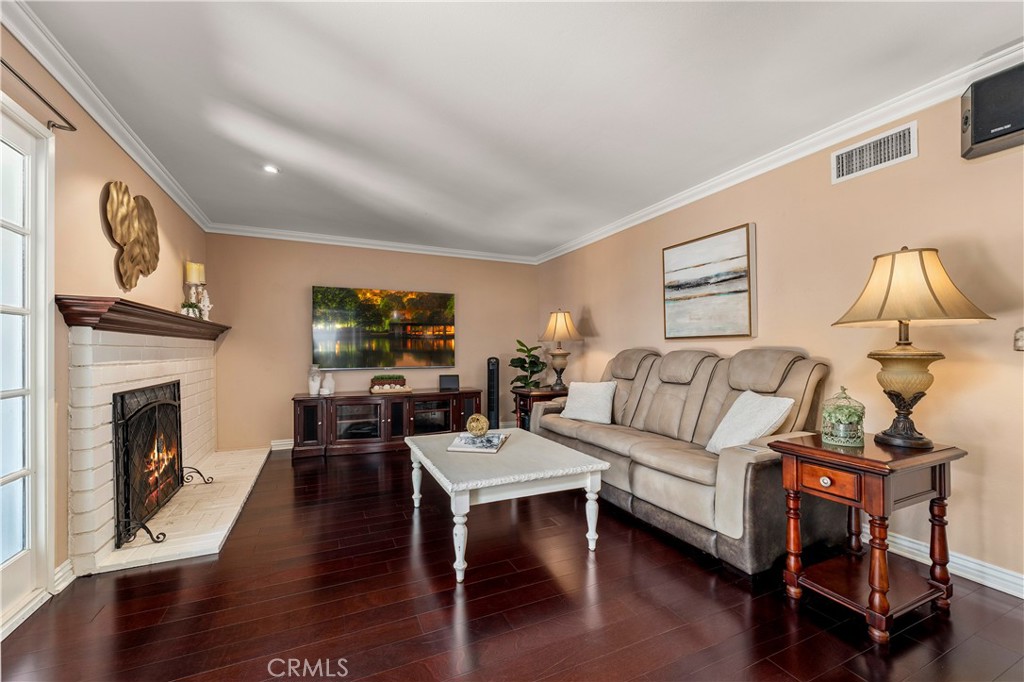 Family room with cozy fireplace. - 390 N Milford Road, Orange CA 92867 - photo 13