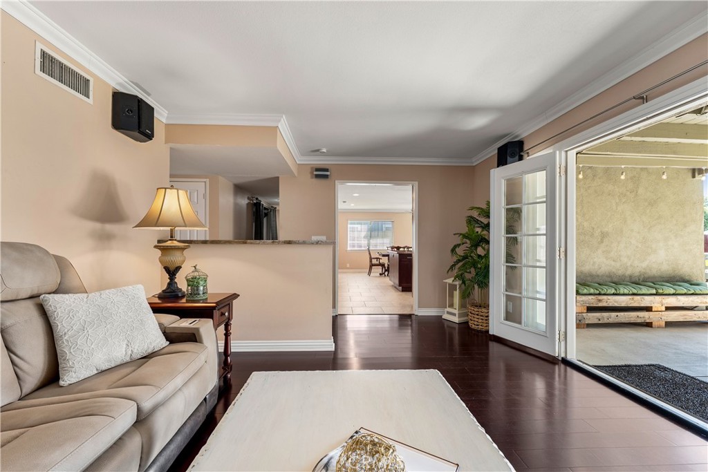 Another shot of the family room leading into the kitchen and back patio area. - 390 N Milford Road, Orange CA 92867 - photo 14