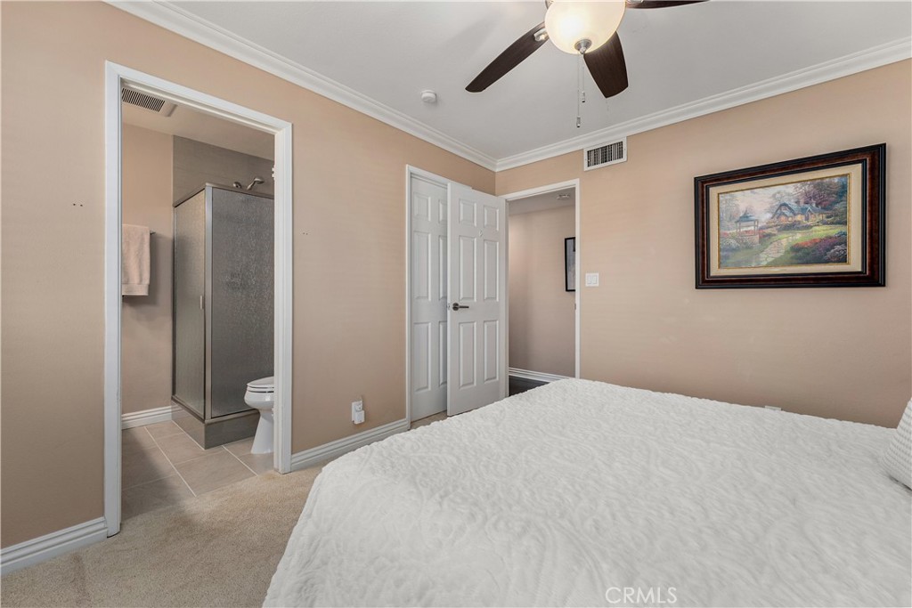 Downstairs primary bedroom with its own en suite bathroom. - 390 N Milford Road, Orange CA 92867 - photo 24