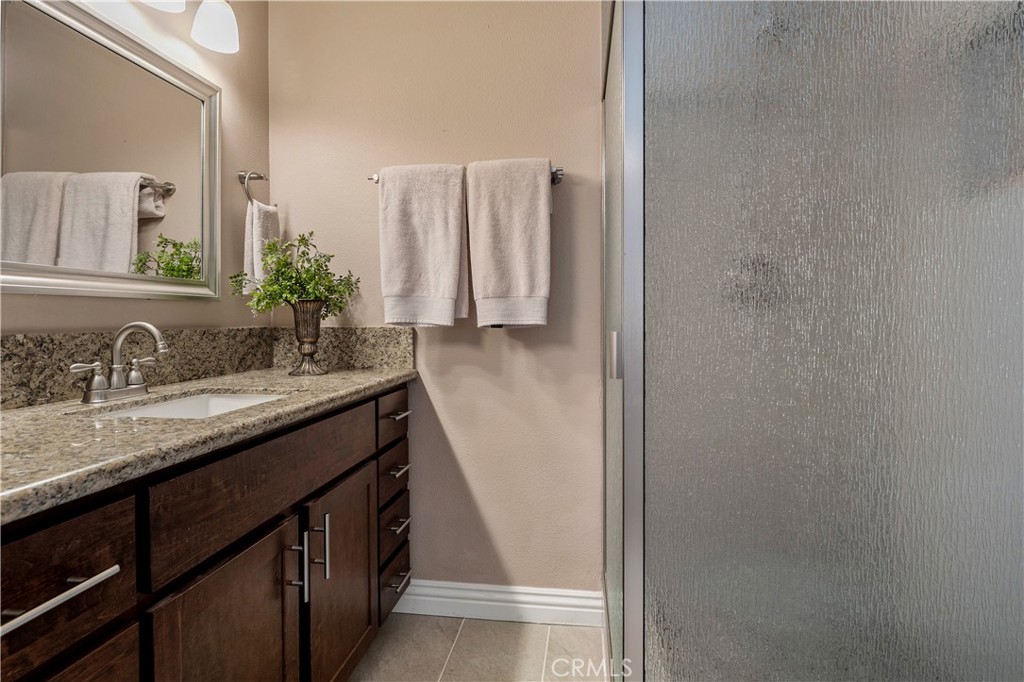 Downstairs primary bedroom, en suite bathroom. - 390 N Milford Road, Orange CA 92867 - photo 25