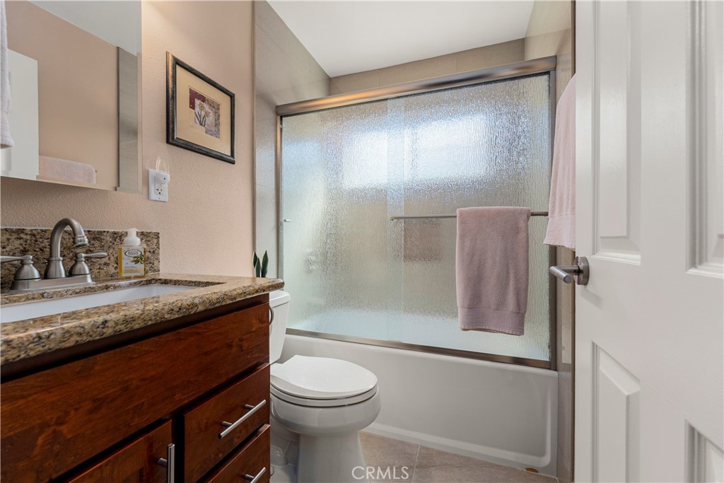 This bedroom outside of the bedroom/office is located at the end of the hallway. - 390 N Milford Road, Orange CA 92867 - photo 29