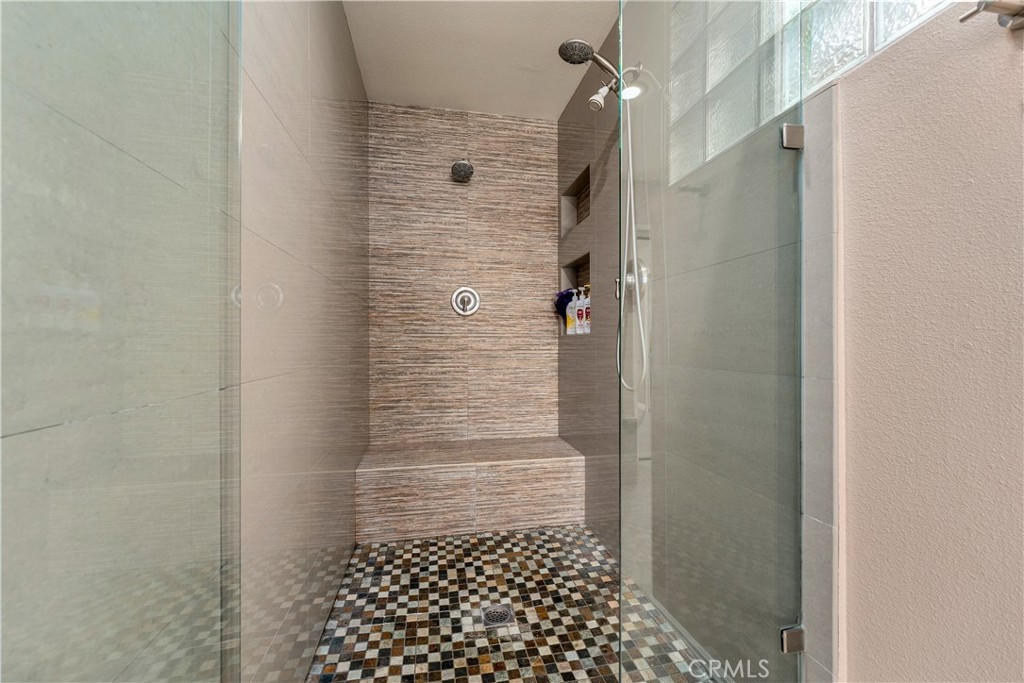 primary en suite bathroom has a custom oversized shower with multiple rain heads. - 390 N Milford Road, Orange CA 92867 - photo 37