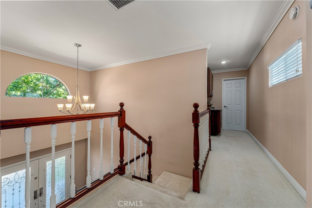 This photo is outside of the primary upstairs bedroom, looking down the hall, which could be a second bathroom upstairs! - 390 N Milford Road, Orange CA 92867 - photo 38