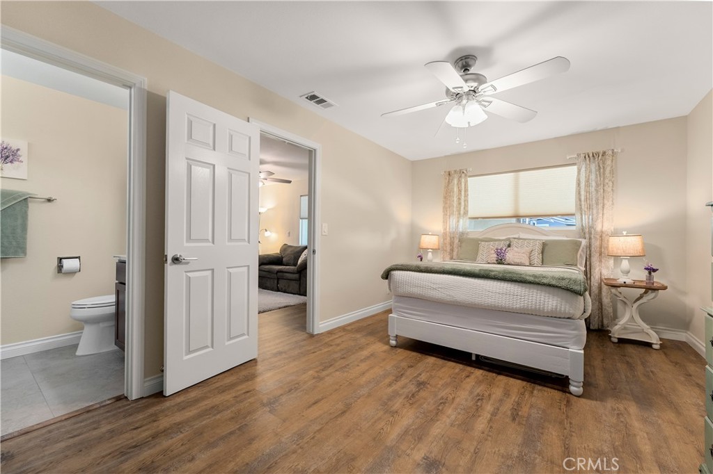Another shot of the primary bedroom with en suite bathroom looking out to living space area. - 390 N Milford Road, Orange CA 92867 - photo 47