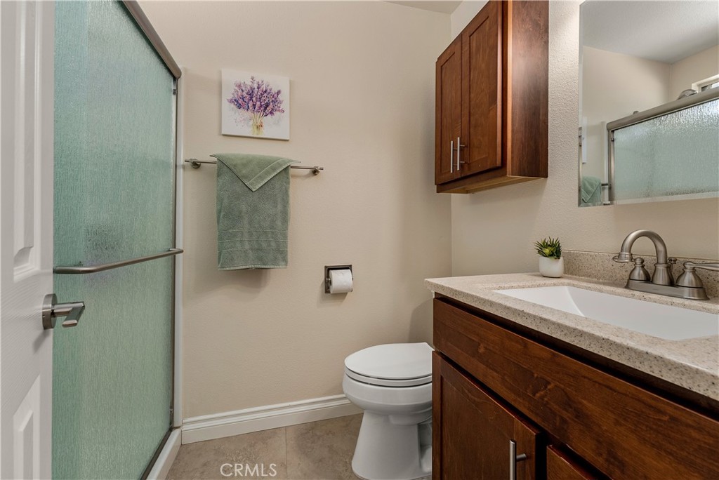 Primary ADU bathroom with standup shower, quartz countertops, and custom cabinetry. - 390 N Milford Road, Orange CA 92867 - photo 48