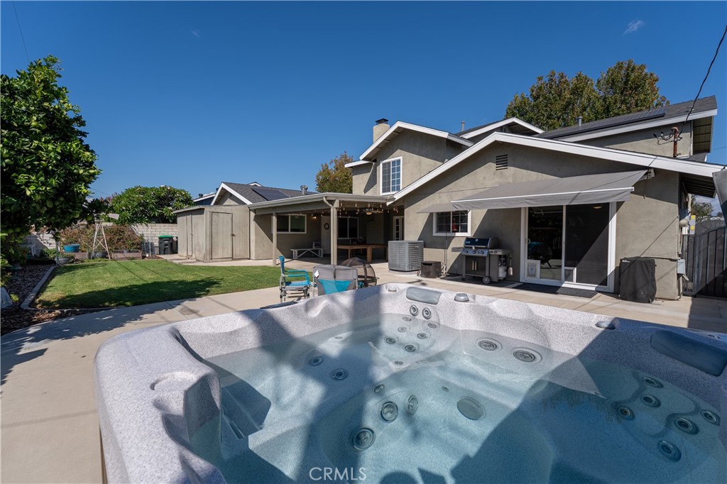 Large back yard with concrete patio area, grass, shed area, garden area and relaxing spa. - 390 N Milford Road, Orange CA 92867 - photo 50