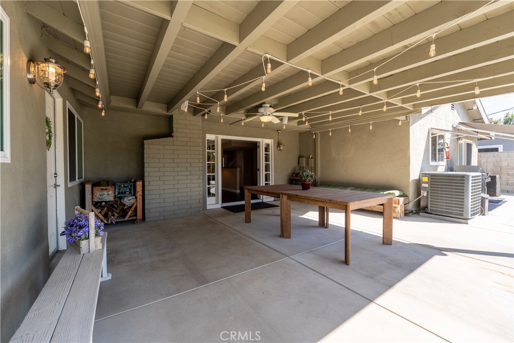 The shot is outside the covered patio, looking into the living room space of the house. - 390 N Milford Road, Orange CA 92867 - photo 57